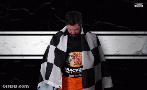A Man Is Wearing A Shirt That Says Bass Pro Shop On It GIF
