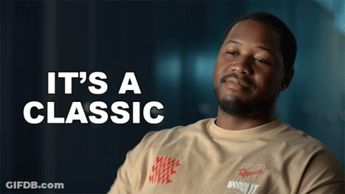 A Man Is Wearing A Shirt That Says It 'S A Classic On It GIF