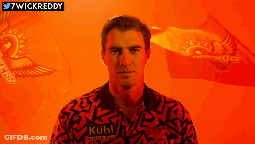 A Man Is Wearing A Shirt That Says " Kuhl " On It GIF
