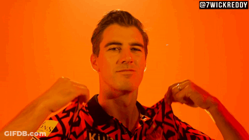 A Man Is Wearing A Shirt That Says ' Kuhl ' On It GIF