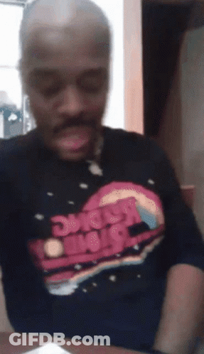 A Man Is Wearing A Shirt That Says Space Wars On It GIF