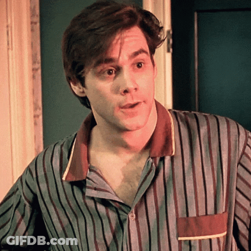 A Man Is Wearing A Striped Shirt And Looking At The Camera GIF