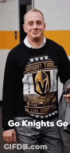 A Man Is Wearing A Sweater That Says Knight Time On It GIF