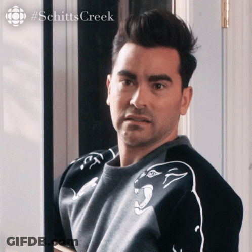 A Man Is Wearing A Sweater With A Panther On It And The Word Schitts Creek Is On The Bottom GIF