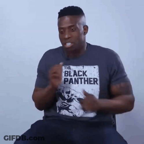 A Man Is Wearing A T-Shirt That Says The Black Panther On It GIF