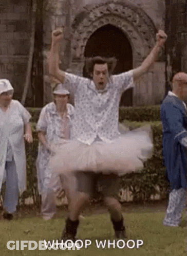 A Man Is Wearing A Tutu And Dancing In A Field . GIF