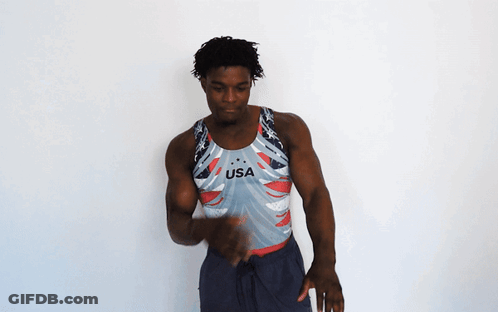 A Man Is Wearing A Usa Tank Top GIF