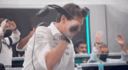 A Man Is Wearing A Virtual Reality Headset While Dancing In A Room . GIF
