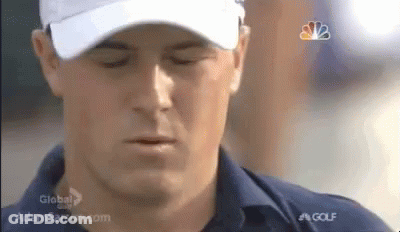 A Man Is Wearing A White Hat And A Blue Shirt . GIF