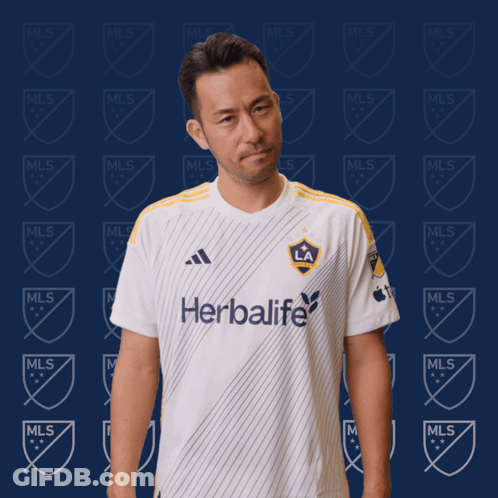 A Man Is Wearing A White Shirt That Says Herbalife GIF