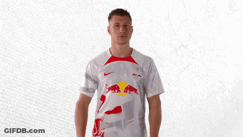 A Man Is Wearing A White Shirt With A Red Bull On It GIF