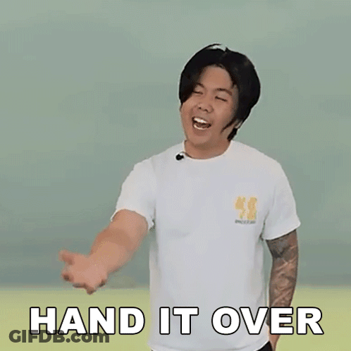 A Man Is Wearing A White T-Shirt And Making A Hand Gesture With The Words Hand It Over Written On It . GIF
