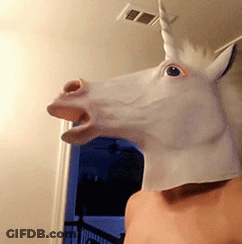 A Man Is Wearing A White Unicorn Mask GIF