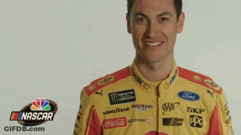 A Man Is Wearing A Yellow And Red Nascar Jersey GIF