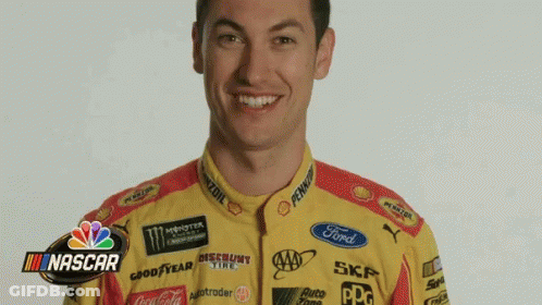 A Man Is Wearing A Yellow And Red Racing Uniform With A Ford Logo On The Front . GIF