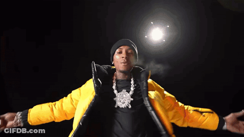 A Man Is Wearing A Yellow Jacket And A Black Beanie GIF
