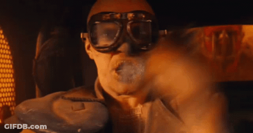 A Man Is Wearing Goggles And Smoking A Cigarette GIF