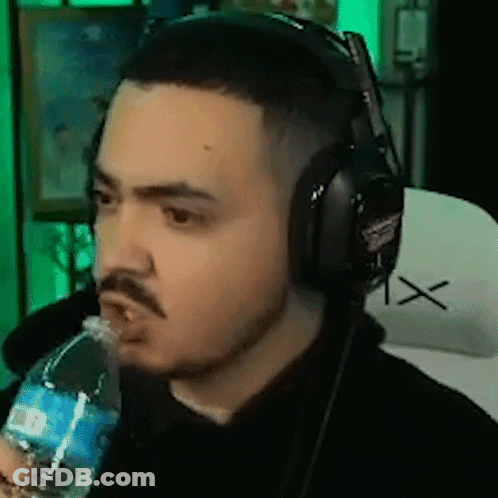 A Man Is Wearing Headphones And Drinking Water From A Bottle . GIF