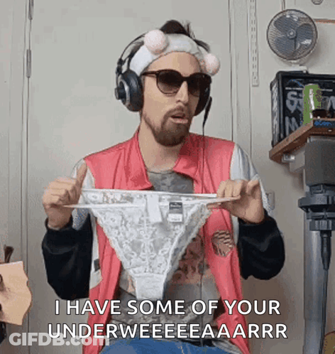A Man Is Wearing Headphones And Holding A Pair Of Underwear . GIF