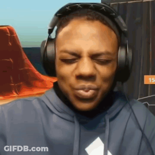A Man Is Wearing Headphones And Making A Face GIF