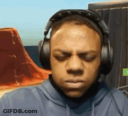 A Man Is Wearing Headphones And Making A Funny Face . GIF