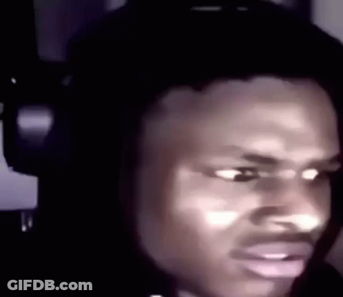 A Man Is Wearing Headphones And Making A Funny Face . GIF
