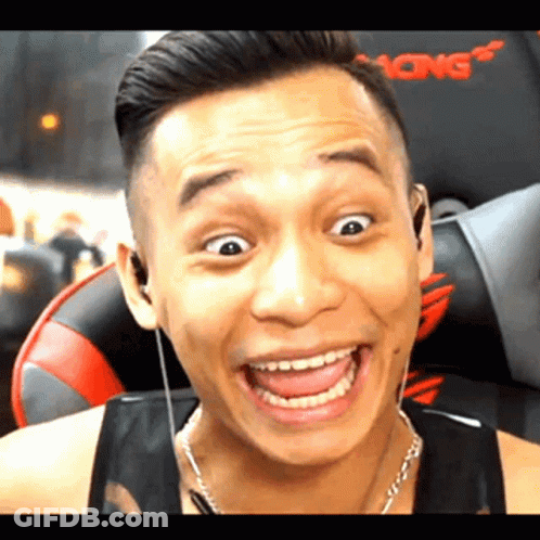A Man Is Wearing Headphones And Making A Funny Face While Sitting In A Gaming Chair . GIF