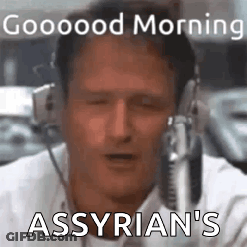 A Man Is Wearing Headphones And Talking Into A Microphone . GIF