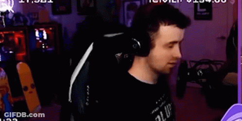 A Man Is Wearing Headphones While Sitting In A Chair . GIF