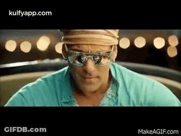 A Man Is Wearing Sunglasses And A Hat While Sitting In A Car . GIF