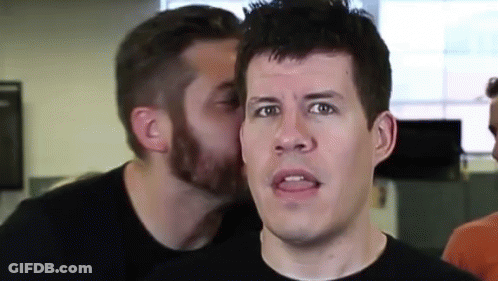 Man Whispering Into Another Man's Ear GIF