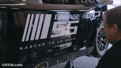 A Man Is Working On A Nascar Car With The Number 56 On It GIF