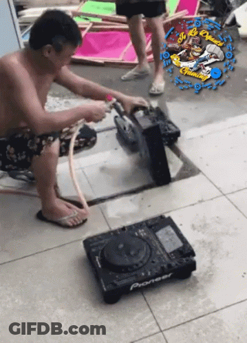 A Man Is Working On A Pioneer Dj Setup GIF