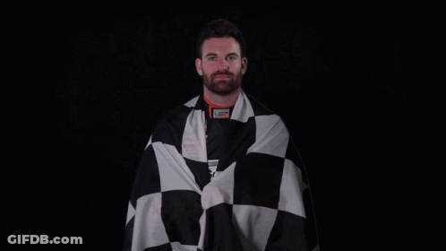 A Man Is Wrapped In A Black And White Checkered Cloth GIF