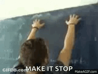 A Man Is Writing On A Blackboard In A Classroom . GIF