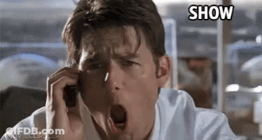 A Man Is Yawning While Talking On A Cell Phone In A Movie . GIF
