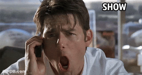 A Man Is Yawning While Talking On A Cell Phone With The Word Show Written Above Him GIF