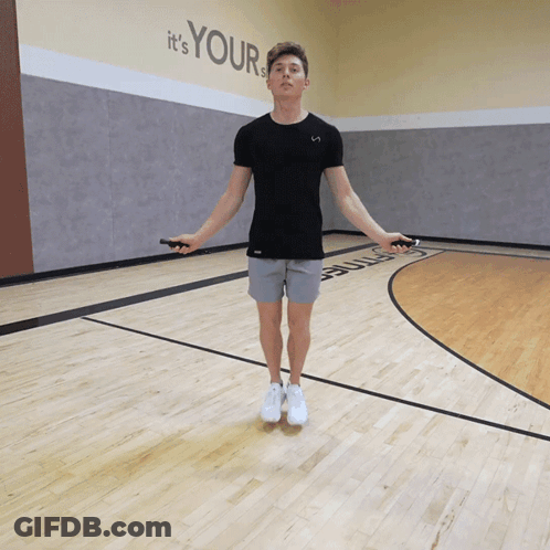 A Man Jumping A Jump Rope In Front Of A Wall That Says " It 'S Your " GIF
