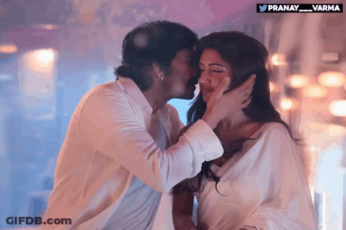 A Man Kisses A Woman On The Forehead With A Pranay_varma Logo In The Corner GIF