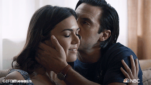 A Man Kisses A Woman On The Forehead With The Hashtag #Thisisus GIF