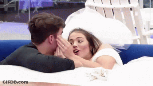 A Man Kissing A Woman In A Wedding Dress In A Pool . GIF