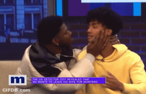A Man Kissing Another Man On A Tv Show With The Letter M On The Bottom Right GIF