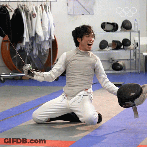 A Man Kneeling On The Floor With A Sword In His Hand GIF