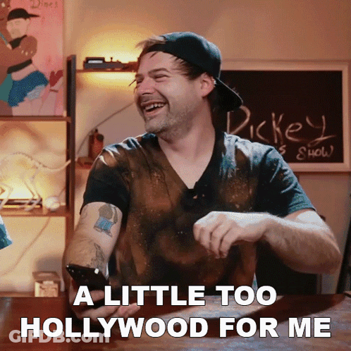 A Man Laughs While Holding A Cell Phone With The Words A Little Too Hollywood For Me GIF