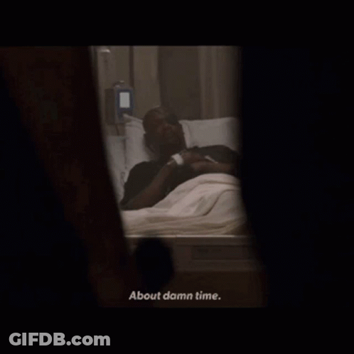 A Man Laying In A Hospital Bed With The Words About Damn Time Below Him GIF