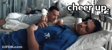 A Man Laying In A Hospital Bed With The Words Cheer Up Written Above Him GIF
