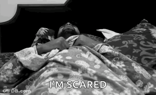 A Man Laying In Bed With The Words I 'M Scared Written Above Him GIF