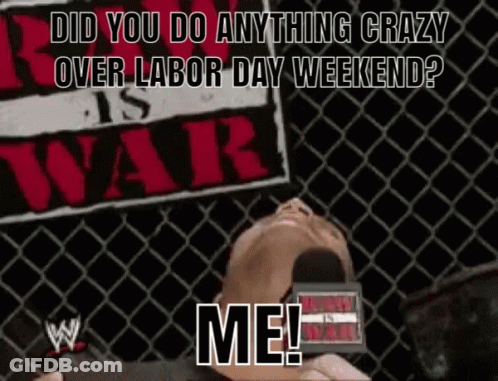 A Man Laying In Front Of A Sign That Says ' Did You Do Anything Crazy Over Labor Day Weekend ? Me ! ' GIF