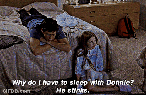 A Man Laying On A Bed Next To A Girl With The Words Why Do I Have To Sleep With Donnie GIF