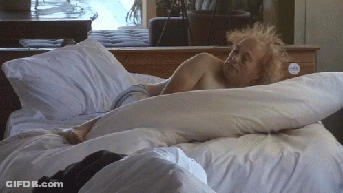 A Man Laying On A Bed With A Sticker On The Nightstand That Says ' I Love You ' On It GIF